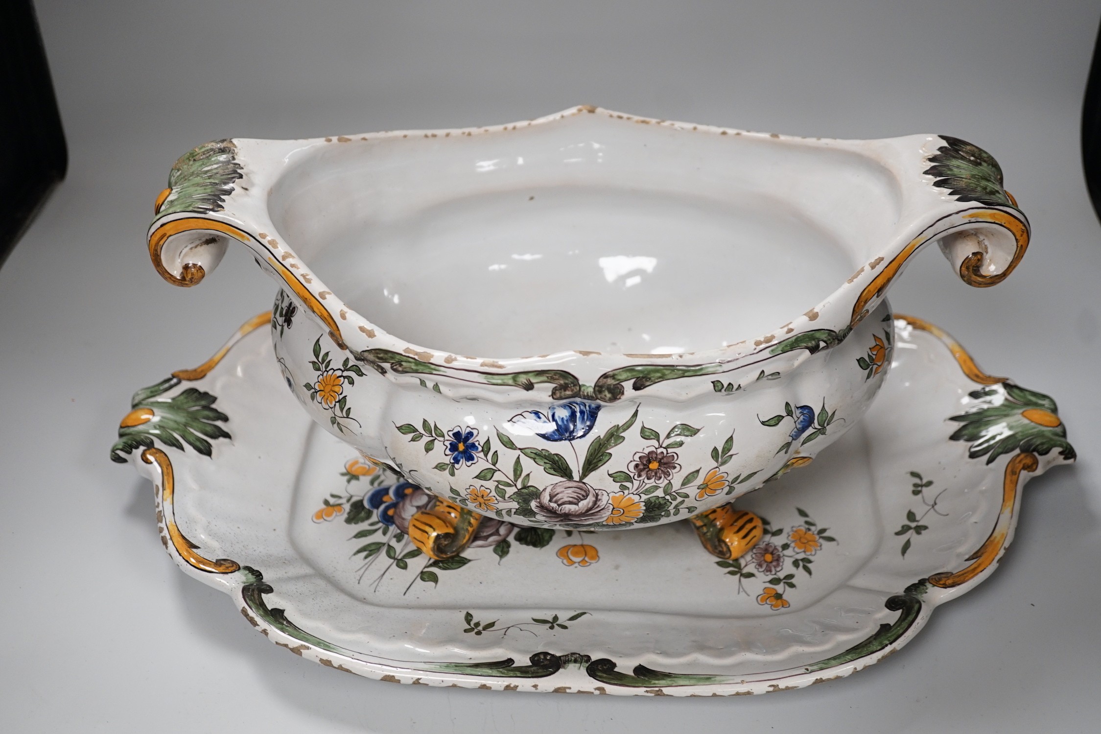 A 19th century French faience large tureen, cover and stand, 49cm wide